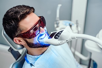 Man in dental chair having teeth whitened